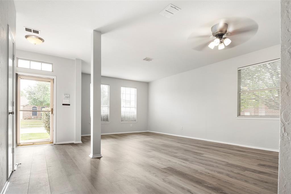 7900 Hidden Path Lane Denton, TX 76210 - Photo 3 of 25 a view of an empty room with a window and wooden floor