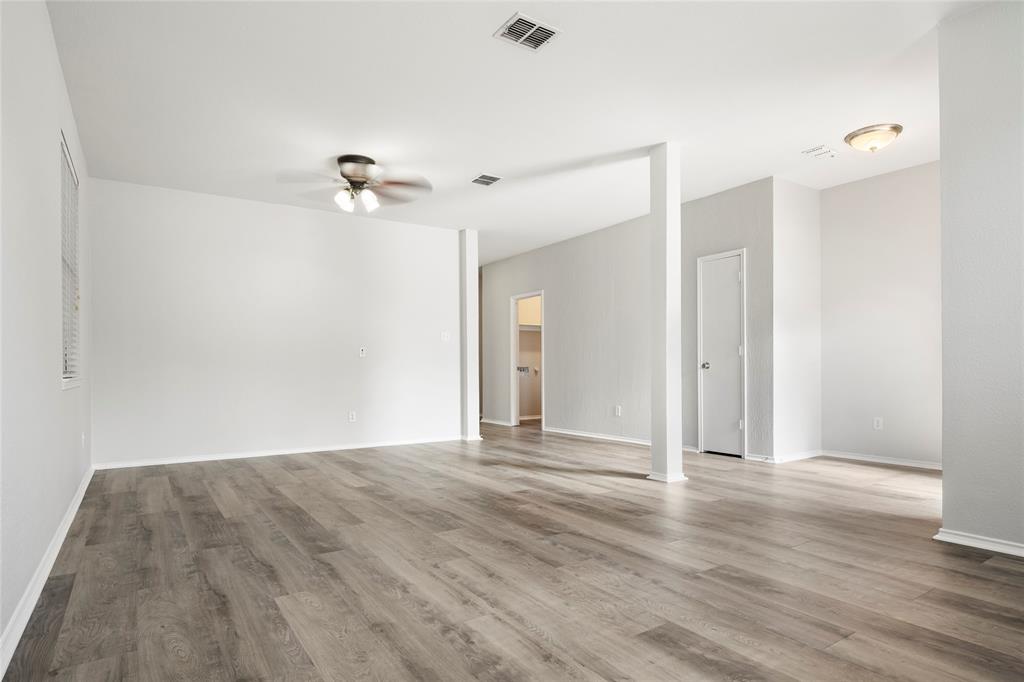 7900 Hidden Path Lane Denton, TX 76210 - Photo 4 of 25 a view of a livingroom with a ceiling fan window and hardwood floor