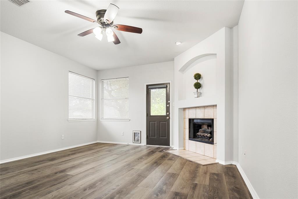 7900 Hidden Path Lane Denton, TX 76210 - Photo 10 of 25 an empty room with windows and fireplace