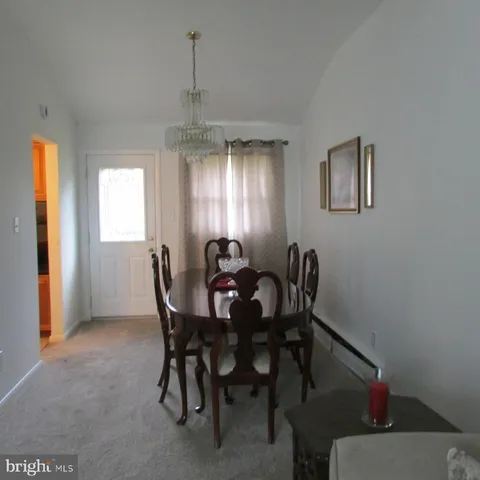 a view of a dining room with furniture and window