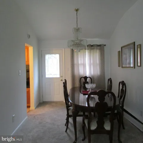 a view of a dining room with furniture and window
