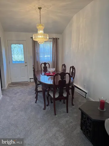a view of a dining room with furniture and window