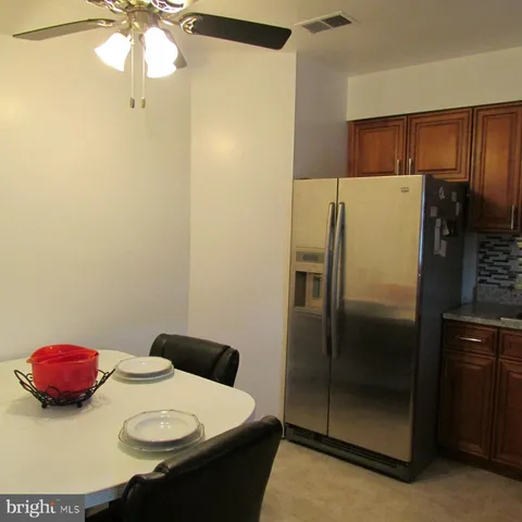 a kitchen with a refrigerator and a more cabinets
