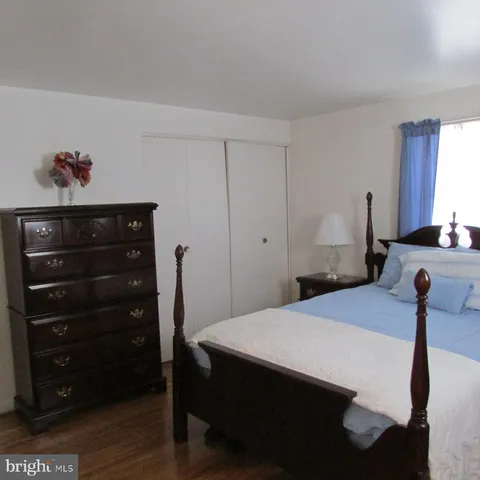 a bedroom with a bed and a dresser