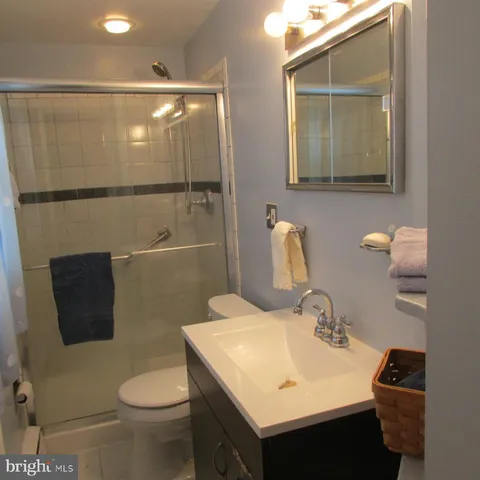 a bathroom with a sink toilet and mirror