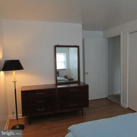 a living room with a table and paintings on the wall