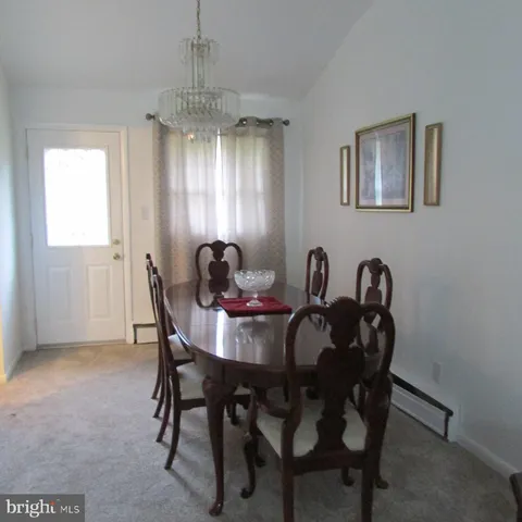 a view of a dining room with furniture and window