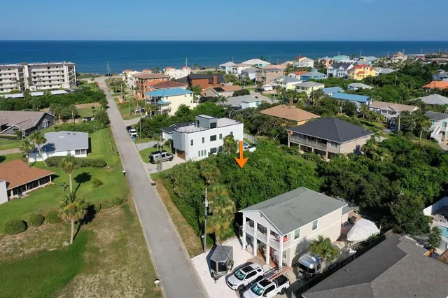 an aerial view of multiple houses with yard