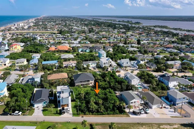 an aerial view of multiple houses with yard