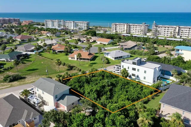 an aerial view of a houses with a yard