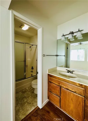 a bathroom with a granite countertop sink shower and a mirror