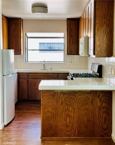 a kitchen with a sink a refrigerator and window