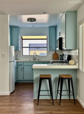 a kitchen with sink cabinets and wooden floor