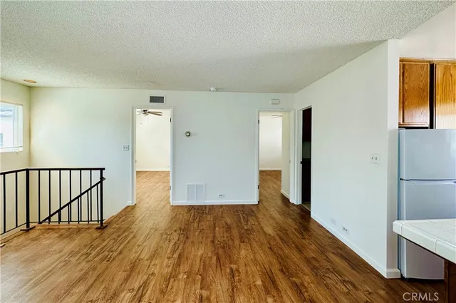 a view of hallway with wooden floor