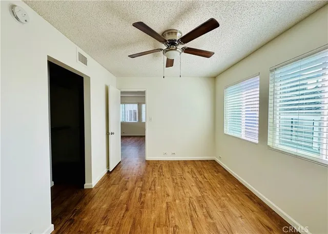 a view of a livingroom with a ceiling fan and wooden floor