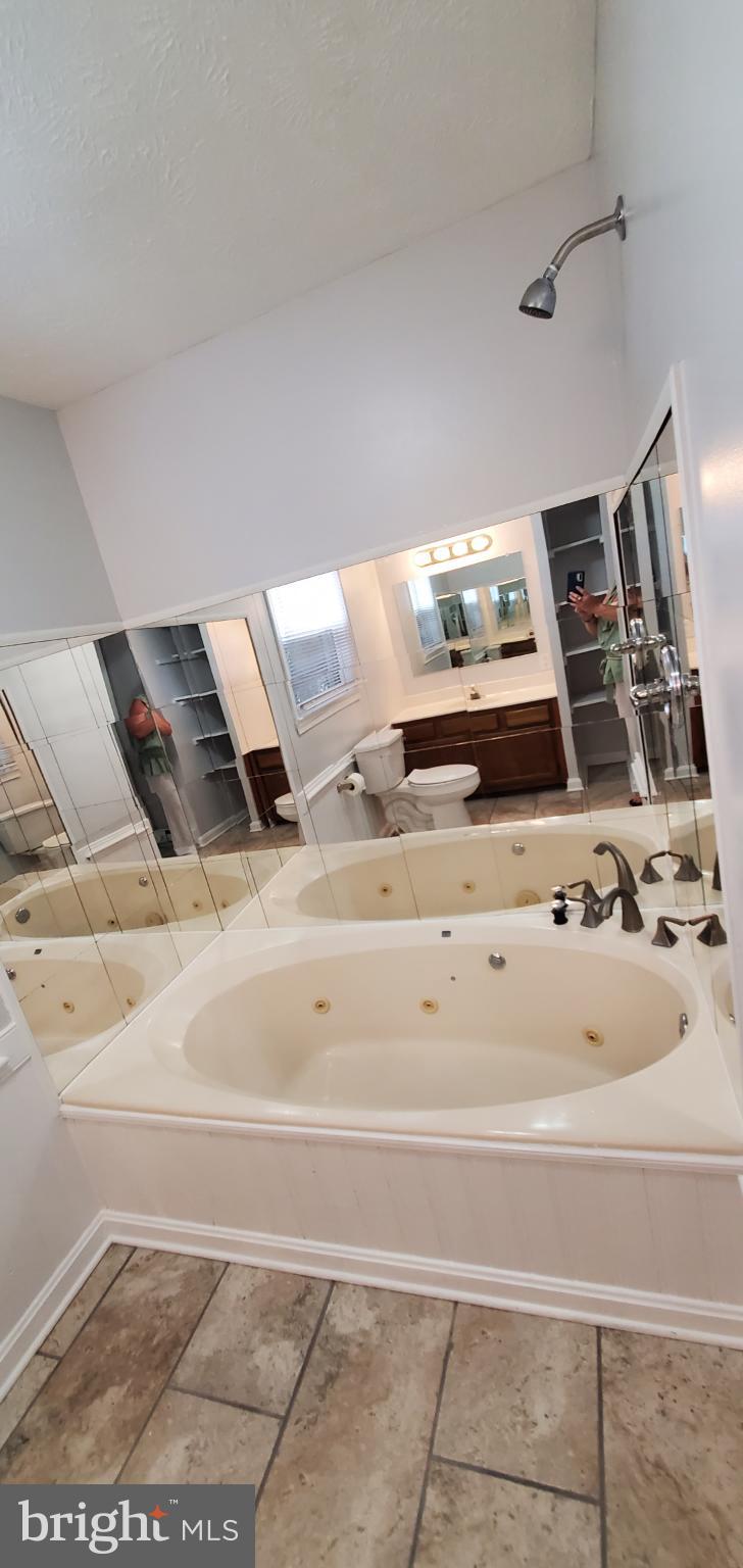 816 North Commerce Avenue, Unit B Front Royal, VA 22630 - Photo 11 of 12 a bedroom with a bed and a cabinets