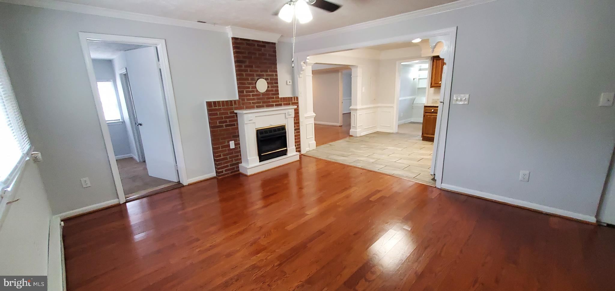 816 North Commerce Avenue, Unit B Front Royal, VA 22630 - Photo 2 of 12 a view of empty room with wooden floor and fireplace
