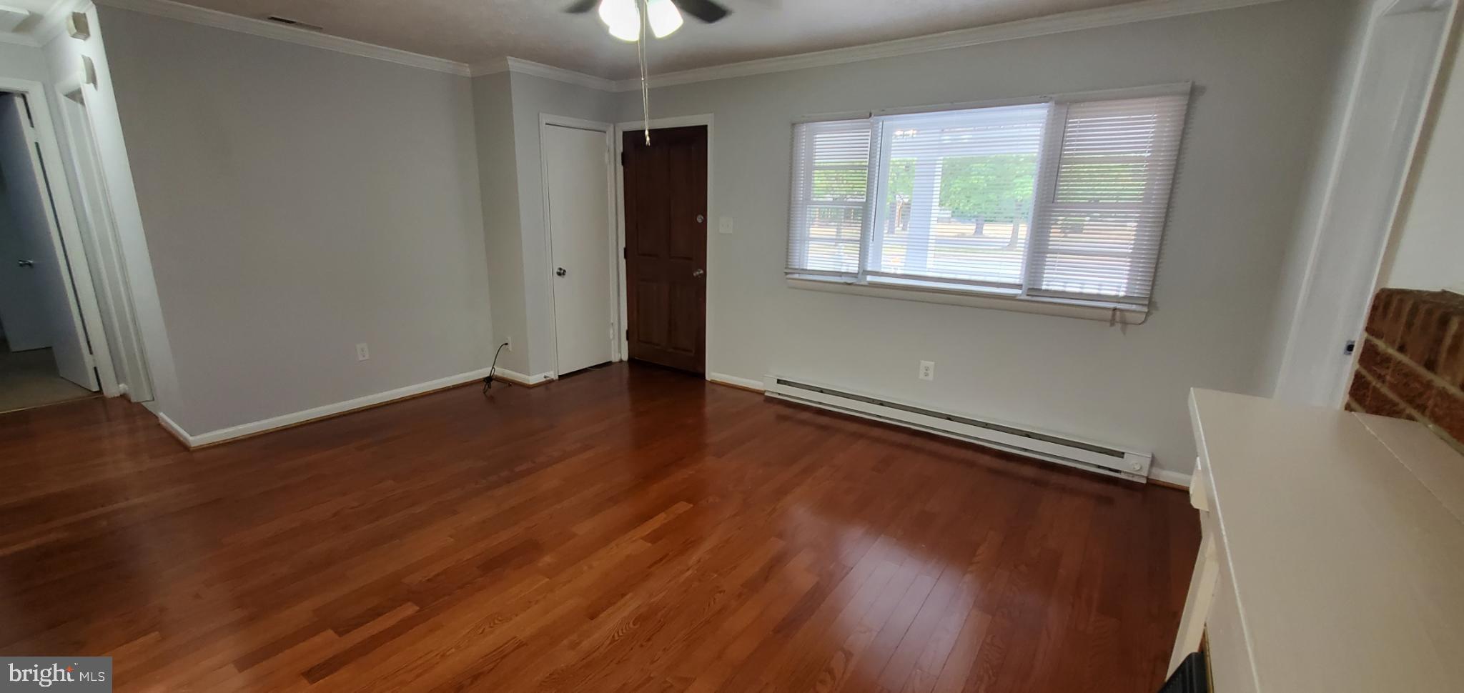 816 North Commerce Avenue, Unit B Front Royal, VA 22630 - Photo 3 of 12 wooden floor in an empty room with a window