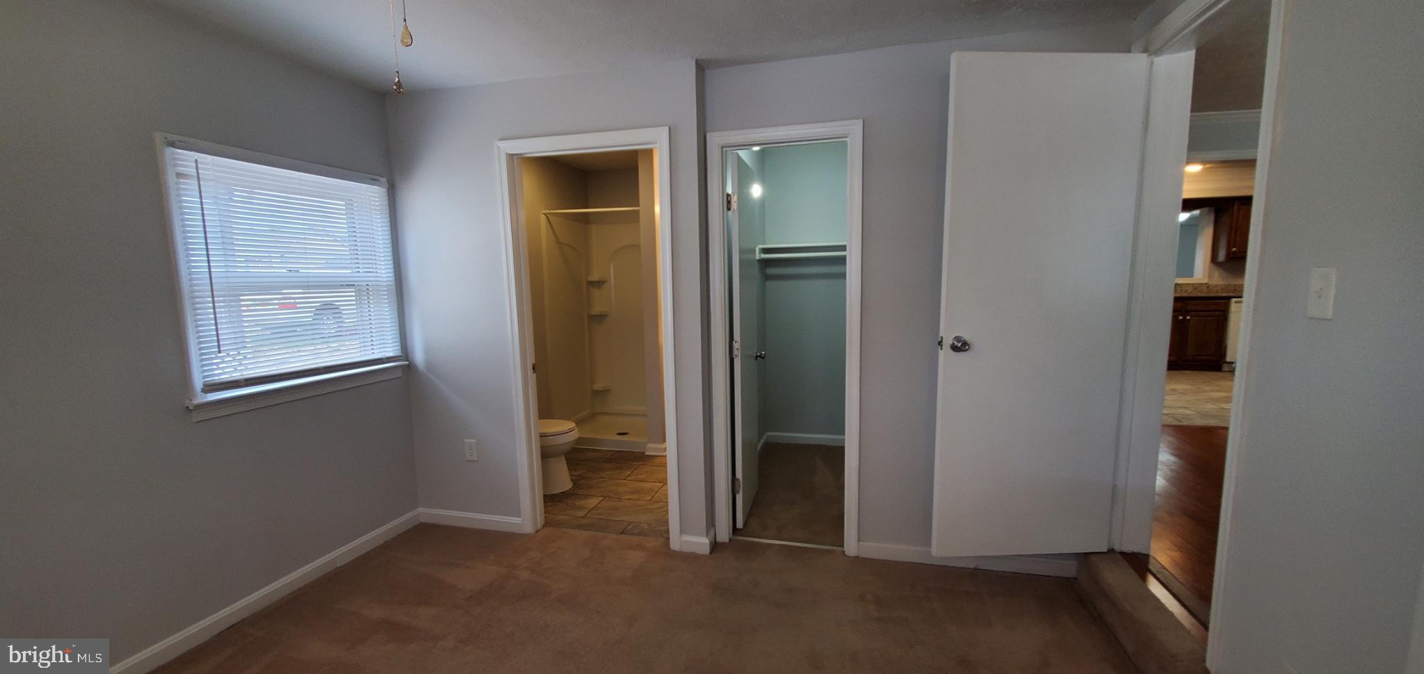 816 North Commerce Avenue, Unit B Front Royal, VA 22630 - Photo 8 of 12 an empty room with windows and closet