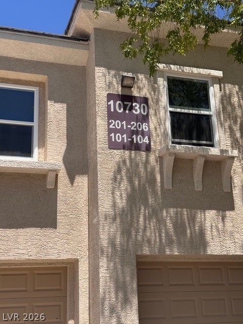 10730 Amber Ridge Drive, Unit 101 Las Vegas, NV 89144 - Photo 3 of 3 Textured stucco facade with clear address markers define this multi-story building's exterior.