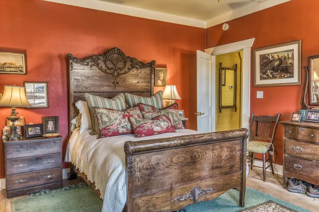 a bed sitting in a bedroom next to a wooden floor