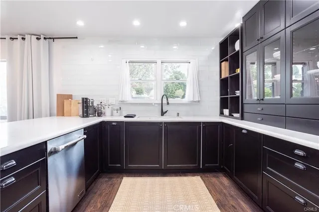 a kitchen with a sink and wooden cabinets