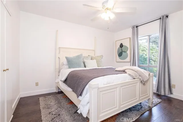 a spacious bedroom with a bed and a window