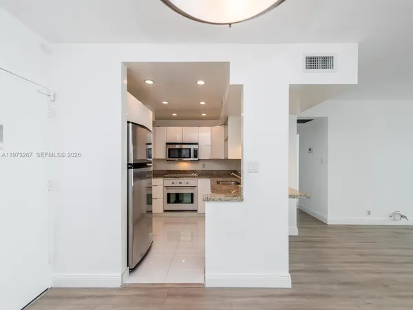 a kitchen with a stove a sink and a refrigerator