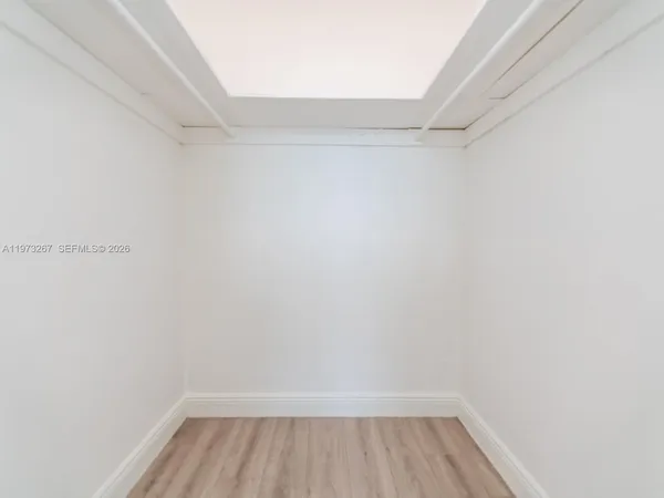 a view of a room with wooden floor