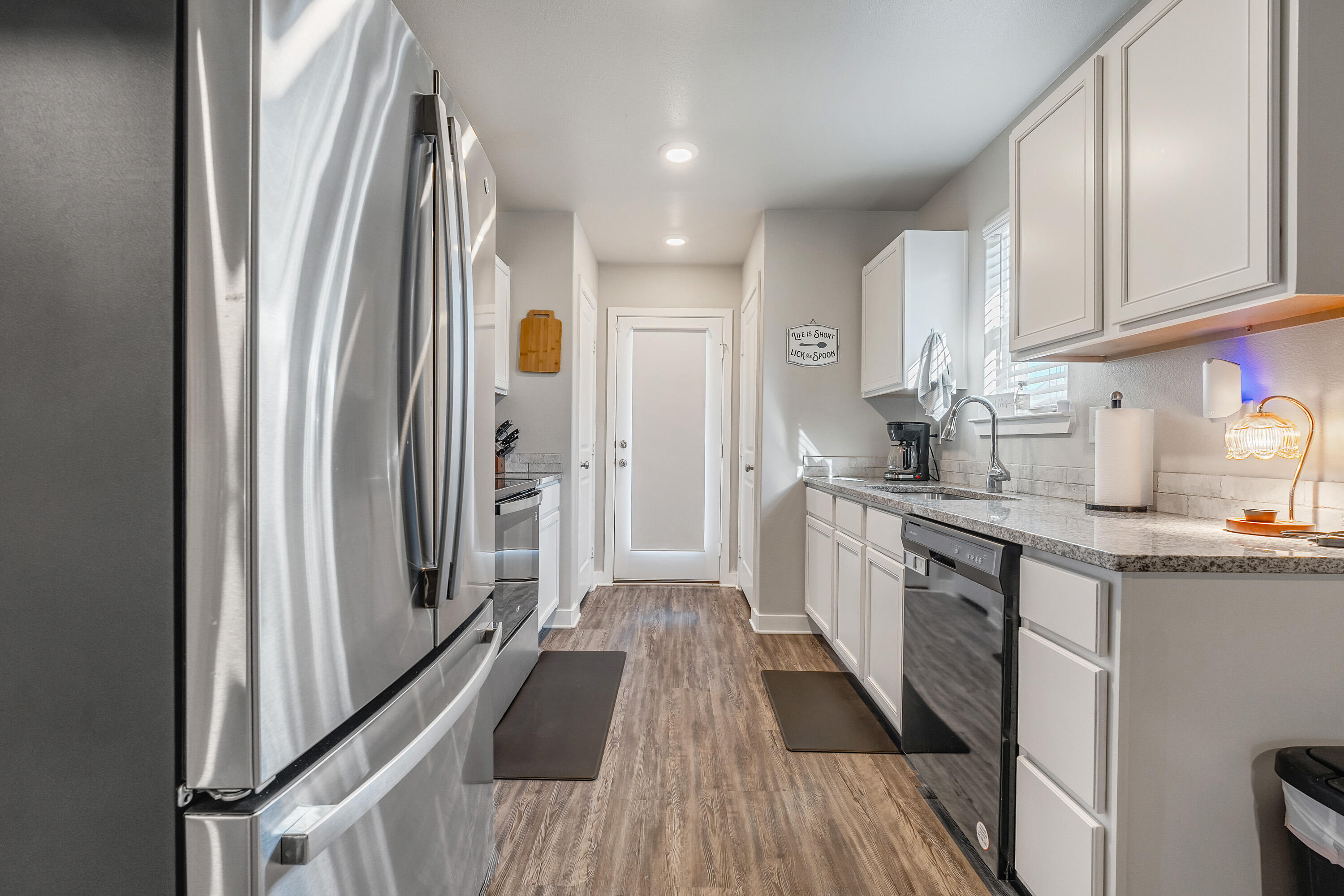 7510 28th Street Lubbock, TX 79407 - Photo 6 of 19 a kitchen with stainless steel appliances granite countertop a refrigerator and a sink