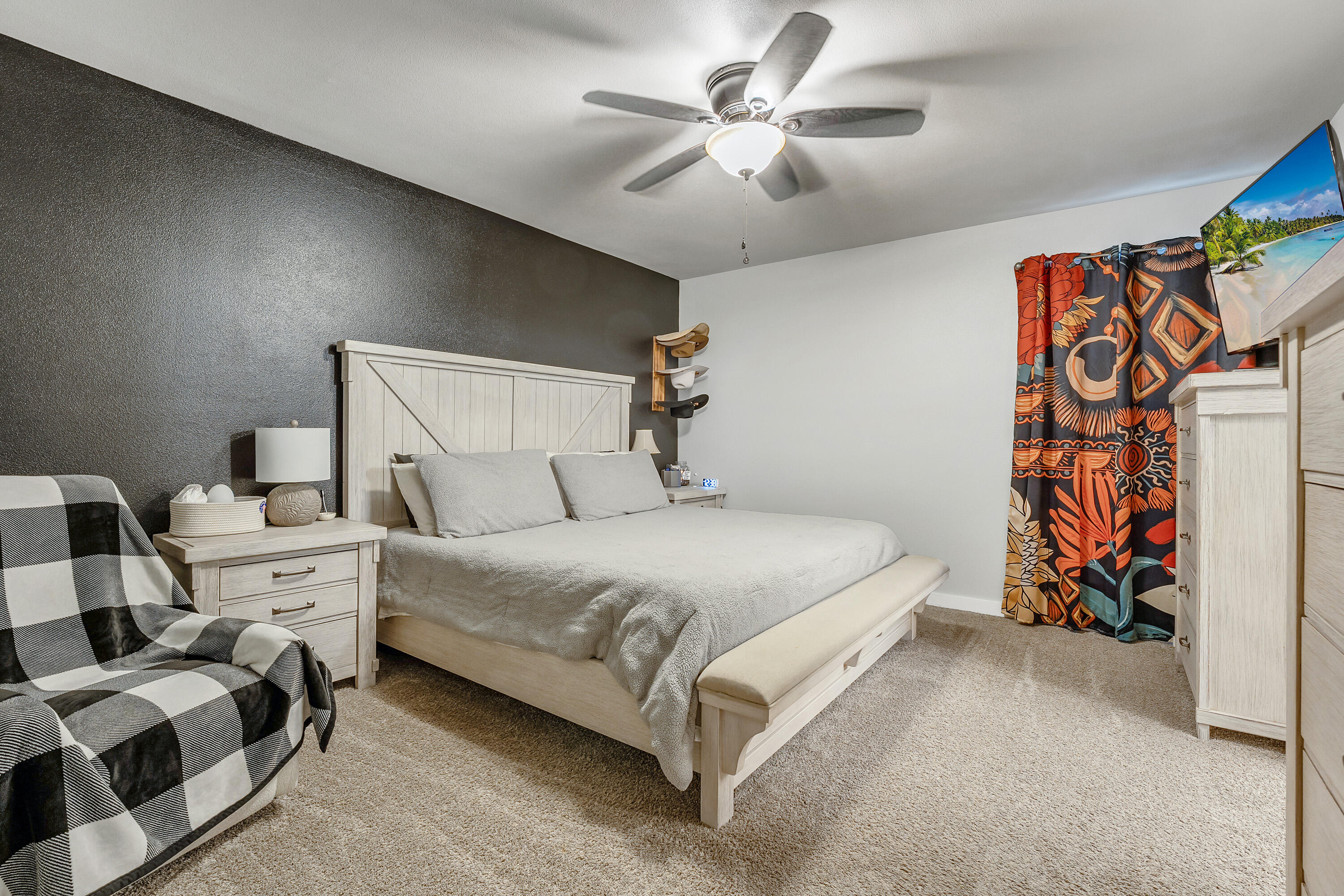 7510 28th Street Lubbock, TX 79407 - Photo 9 of 19 a bed room with a bed and a ceiling fan