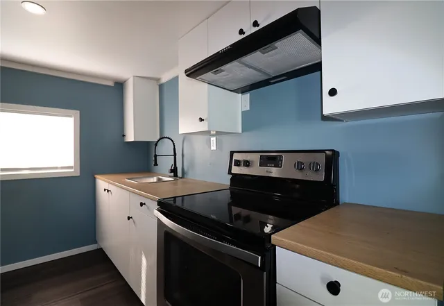 a kitchen with a stove and a microwave