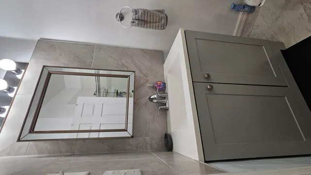 a bathroom with a granite countertop toilet a sink and shower