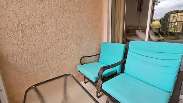 a view of a chair and table in a balcony