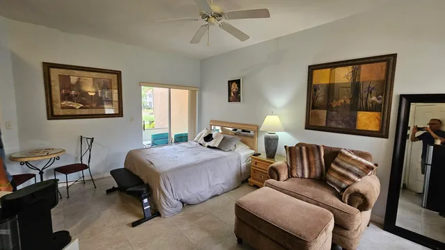 a bedroom with furniture and a window