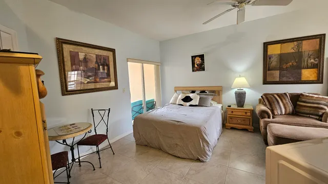 a bedroom with a bed and chair