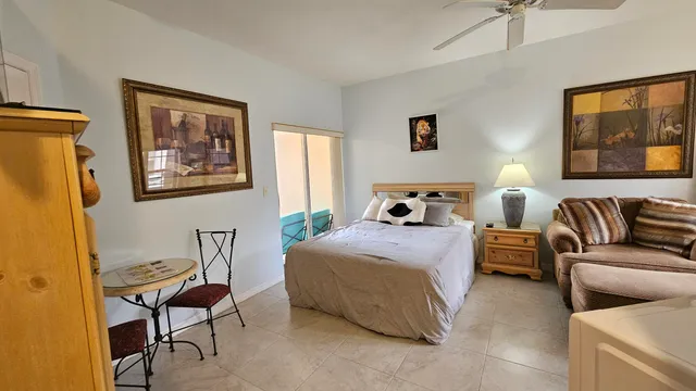 a bedroom with a bed and chair