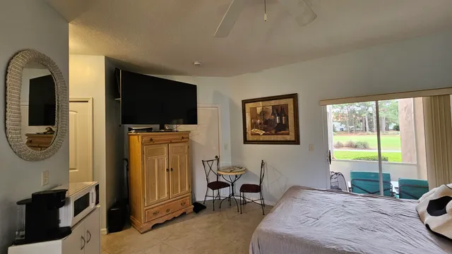 a bedroom with furniture and a flat screen tv