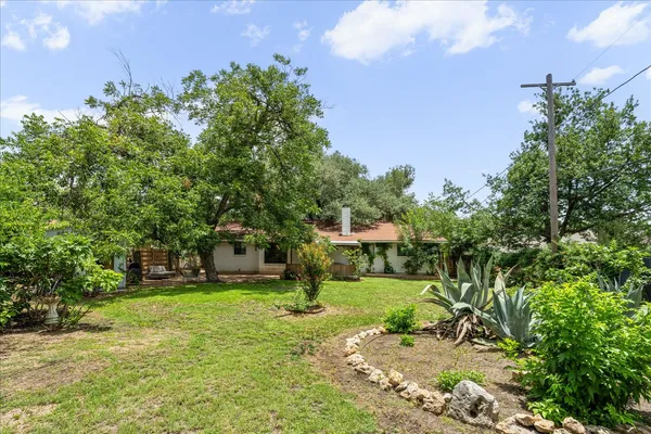 a view of a backyard with sitting area