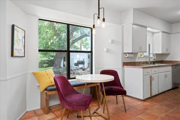 a dining room with furniture and a flat screen tv