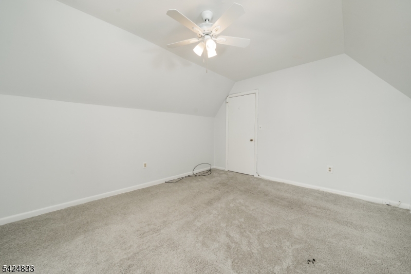 331 Main Street Chatham, NJ 07928 - Photo 11 of 15 an empty room with a ceiling fan and a window