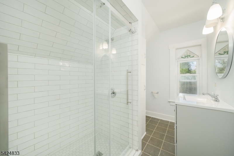 331 Main Street Chatham, NJ 07928 - Photo 5 of 15 a bathroom with a granite countertop shower and a sink
