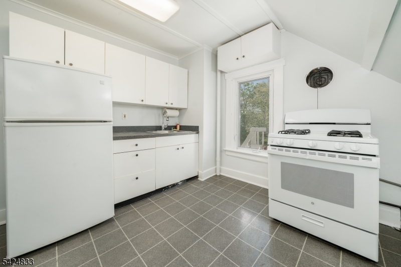 331 Main Street Chatham, NJ 07928 - Photo 6 of 15 a kitchen with a stove cabinets and a refrigerator