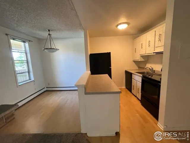 a kitchen with a stove a sink and a refrigerator