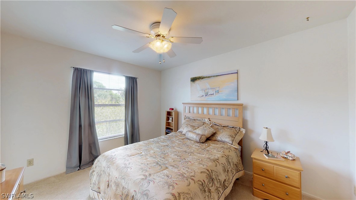1100 Pondella Road, Unit 811 Cape Coral, FL 33909 - Photo 11 of 35 a bedroom with a bed and a window