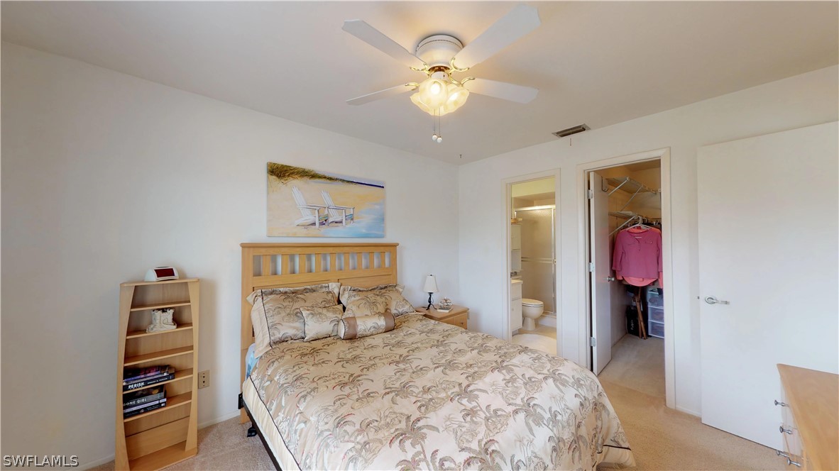 1100 Pondella Road, Unit 811 Cape Coral, FL 33909 - Photo 12 of 35 a bedroom with a bed and a chandelier