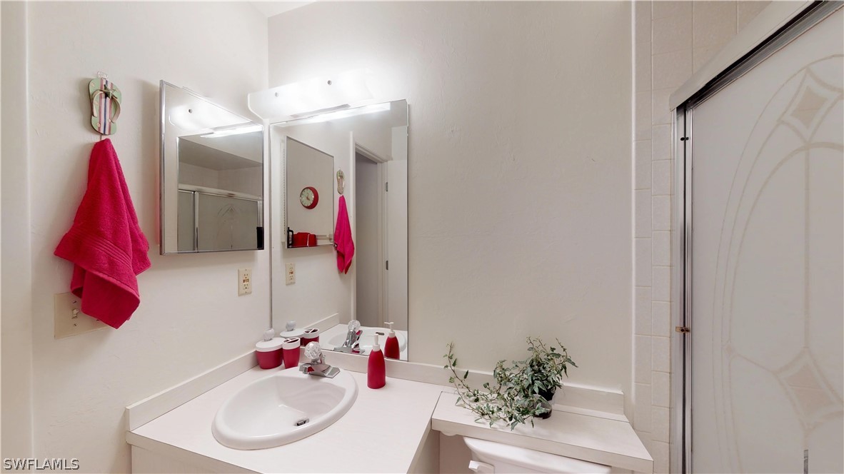 1100 Pondella Road, Unit 811 Cape Coral, FL 33909 - Photo 18 of 35 a bathroom with a sink and a mirror