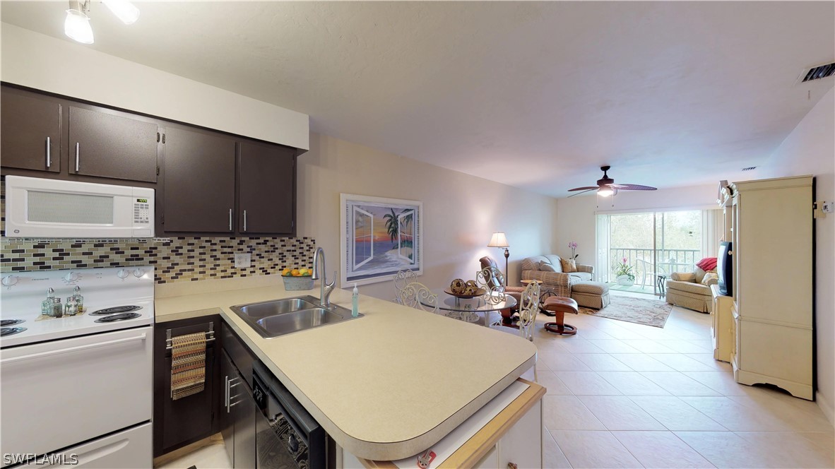 1100 Pondella Road, Unit 811 Cape Coral, FL 33909 - Photo 2 of 35 a very nice looking dining room with kitchen island a stove a sink dishwasher and a refrigerator with wooden floor