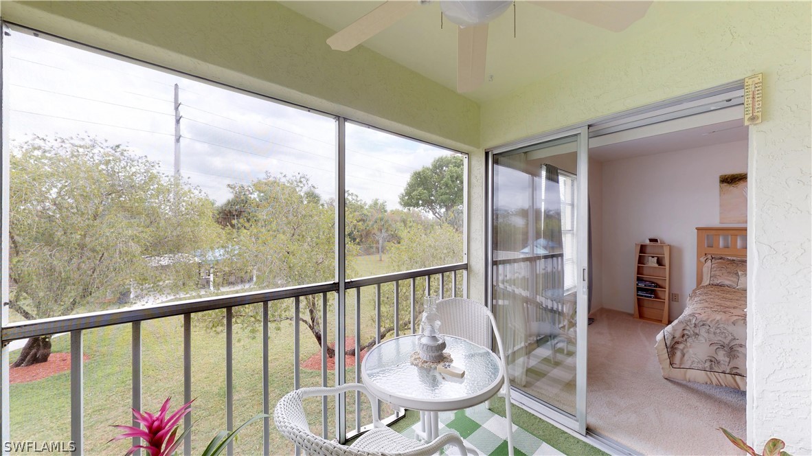 1100 Pondella Road, Unit 811 Cape Coral, FL 33909 - Photo 22 of 35 a living room with furniture and a floor to ceiling window
