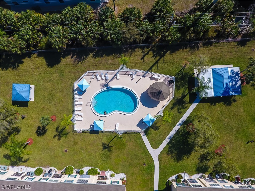 1100 Pondella Road, Unit 811 Cape Coral, FL 33909 - Photo 27 of 35 an aerial view of a house with a swimming pool and outdoor seating
